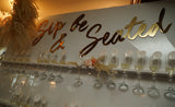 Sip and Be Seated Champagne Wall