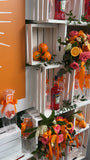 Crate Backdrop w/Custom sign, 4 floral arrangements, 4 orange mini arrangements