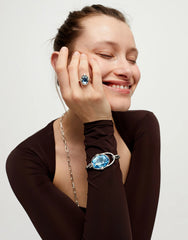 Rigid Bracelet Of Metal Alloy Plated In Sterling Silver With A Blue Faceted Crystal